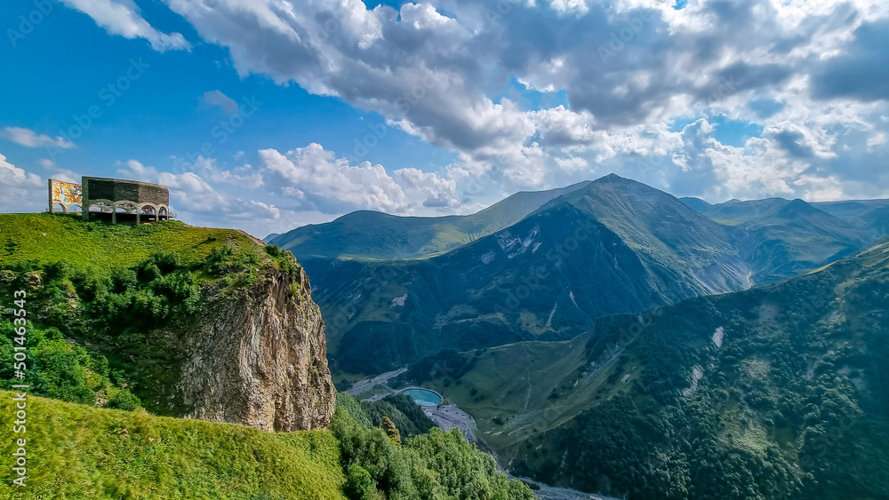 Scenic view of Gudauri Arch in Georgia- the Russia Georgia Friendship Monument or Treaty of Georgievsk Monument. green mountains of the Greater Caucasus Mountain Ranges. Georgian Military Road