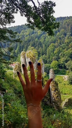 The hand of a woman with a  view on Skala Biala Reka (the White Hand rock) in the Ojcow National Park near Krakow, Lesser Poland, Poland.Limestone rock formation. Jurassic Krakow-Czestochowa Upland photo