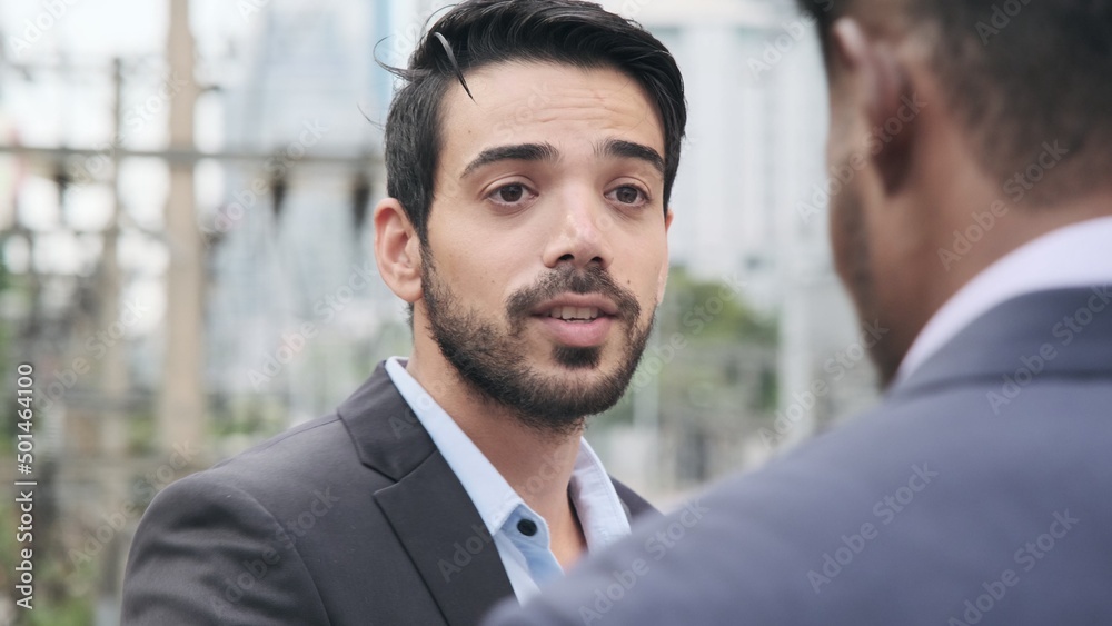 Fototapeta premium Caucasian handsome businessman talking to african american black businessman about new business.