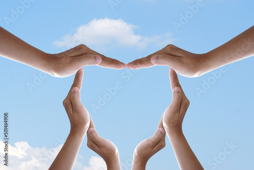 human hand made heart blue sky background