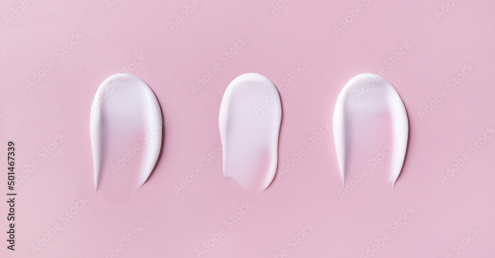 banner cosmetic smears cream texture on pastel pink background	
