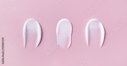 banner cosmetic smears cream texture on pastel pink background 