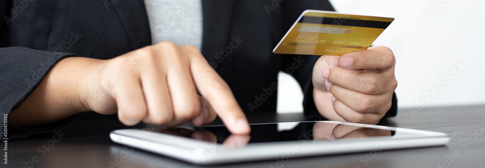women use Tablet to register online purchases using credit card payments, Convenience in the world of technology and the internet, Shopping online and banking online concept. women use Tablet to register online purchases using credit card payments, Convenience in the world of technology and the internet, Shopping online and banking online concept.