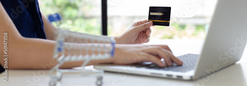 women use laptop to register online purchases using credit card payments, Convenience in the world of technology and the internet, Shopping online and banking online concept...
