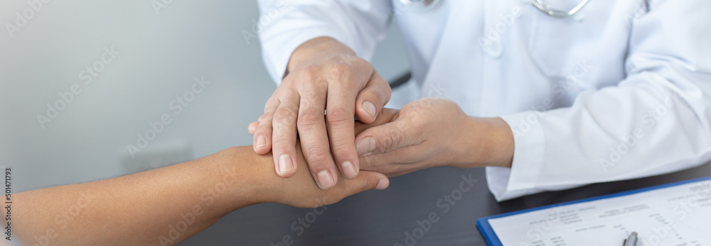 Doctors in white robes hold the hands of patients to create comfort and confidence for patients to improve health, Comfort and encouragement concept. Doctors in white robes hold the hands of patients to create comfort and confidence for patients to improve health, Comfort and encouragement concept.