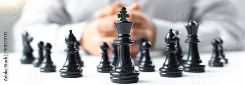 Business men make plans to play chess with Prudence and success, Management or leadership concept.