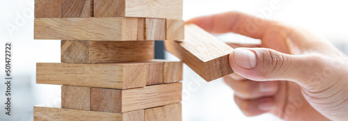 Business people play wooden games, divide the average investment value of a business and jointly manage risks, Alternative risk plan and strategy in business.