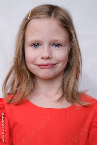 Portrait of blonde beautiful little girl with blue eyes