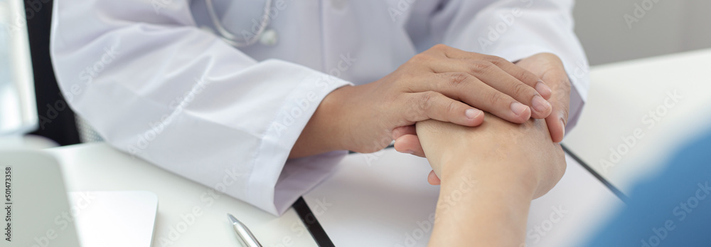 Two people shaking hands, Doctor comforted or encouraged the patient in the operating room of the hospital, Psychological behavior concept. Two people shaking hands, Doctor comforted or encouraged the patient in the operating room of the hospital, Psychological behavior concept.