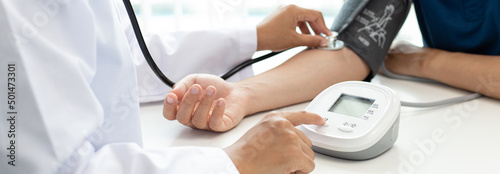Принти на полотні Female doctors use blood pressure monitors and stethoscope to measure pulse Diagnose the patient's disease in a modern hospital medical laboratory, Medical treatment and health care concept