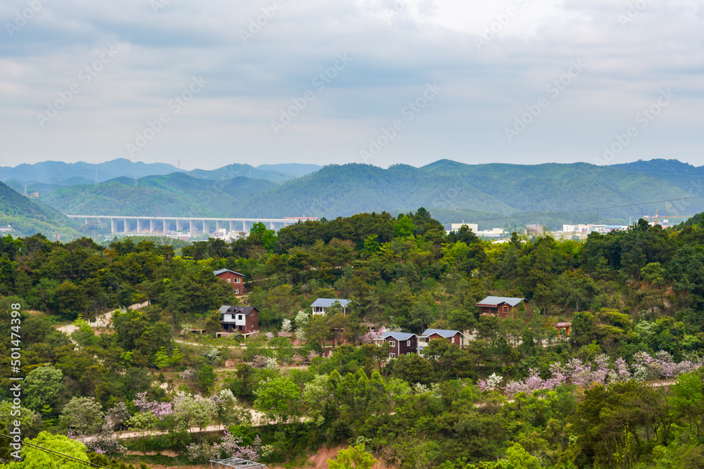 Fototapeta premium Suburban mountain landscape and distant mountains in Nanning, Guangxi, China