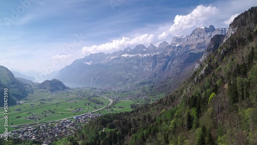 Aerial forward panorama of the mighty mountain range Churfirsten in Switzerland