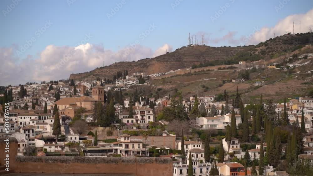 Pan across houses and hills in Granada seen from Alhambra Pan across houses and hills in Granada seen from Alhambra