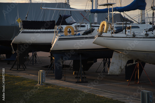 Boats parked on the ground lined in a row on beautiful sunset light in Tallinn, Estonia