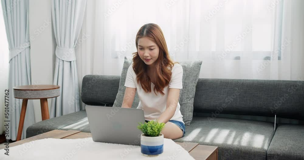 Smiling young businesswoman using laptop sitting at home office desk, happy female customer make distant online work Smiling young businesswoman using laptop sitting at home office desk, happy female customer make distant online work
