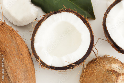 Fresh coconut on white background. Home spa treatment concept, organic cosmetic. Close up.