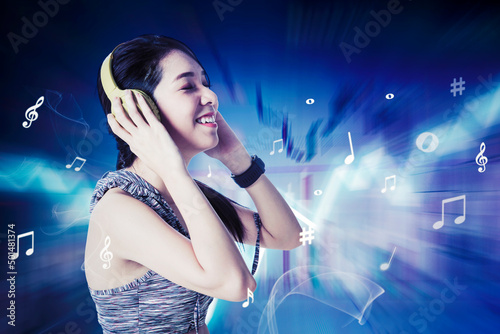 Sporty woman listening music with headphones