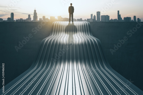 Back view of thoughtful young businessperson standing on abstract wave staircase on city background. Career, success and growth concept. photo