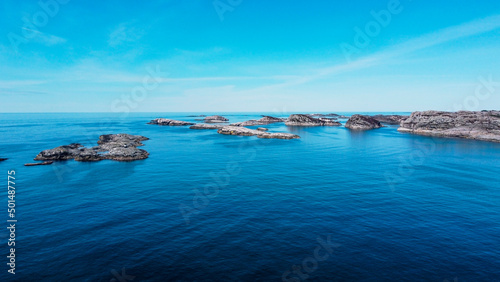 Aerial view of the sea wave and rocks of the coastline of Norway, Telavåg. Panoramic view of the rocks by the sea. The sea wave rolls along the shore. View of the sea coast from the air. Ocean space