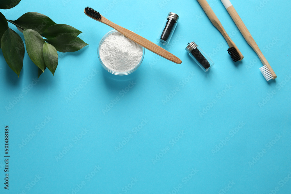 Bowl of tooth powder, brushes, dental flosses and plant on turquoise background, flat lay. Space for text Bowl of tooth powder, brushes, dental flosses and plant on turquoise background, flat lay. Space for text