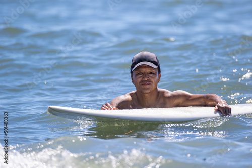 湘南の海でサーフィンをする男性 © D maborosi