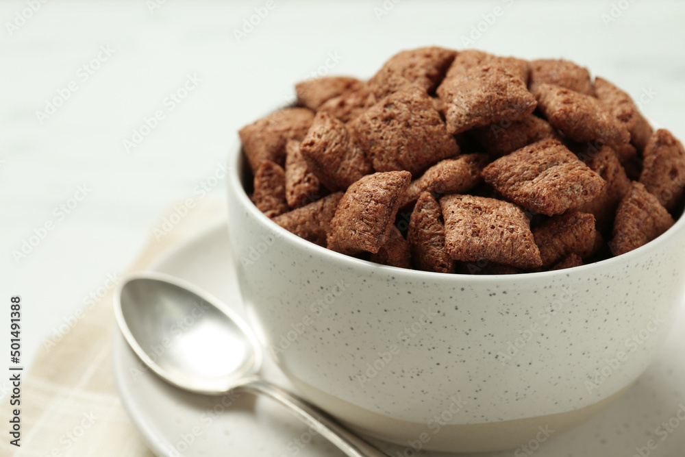 Bowl of sweet crispy chocolate corn pads on table, closeup Bowl of sweet crispy chocolate corn pads on table, closeup