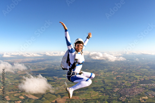 Fotografie, Obraz Beautiful woman skydiving in freefall, adventure freedom concept