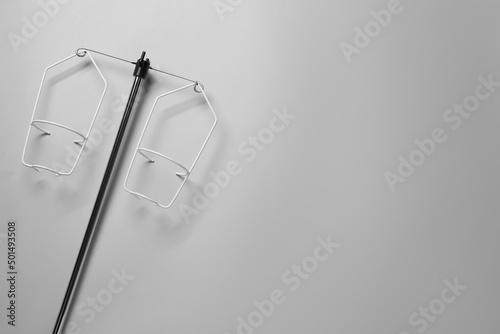 Intravenous pole on light grey background, top view. Space for text