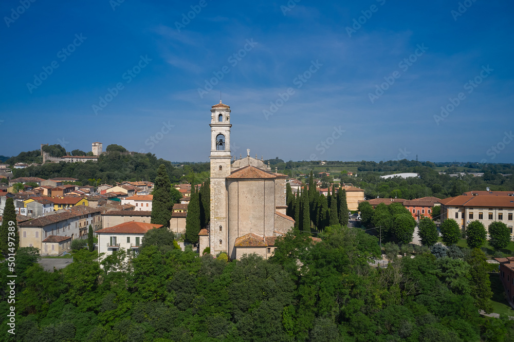 Church San Michele Church in Monzambano in Italy in a historic town. Historic churches of Italy drone view. aerial view of the italian church by the river.