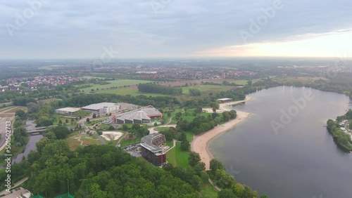 Wolfsburg, Germany: Aerial view of city in Lower Saxony, lake Allersee in morning - landscape panorama of Europe from above photo