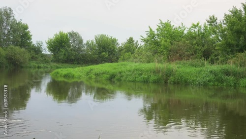 Sunrise on the river in the fog. Evening landscape with the last rays. Beautiful nature in summer