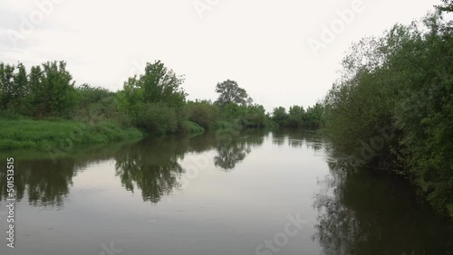 Sunrise on the river in the fog. Evening landscape with the last rays. Beautiful nature in summer