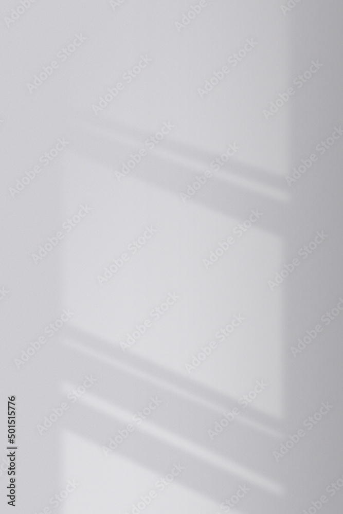 Sunlight shining through the window hits the concrete gray wall inside the room, vertical view. Sunlight shining through the window hits the concrete gray wall inside the room, vertical view.