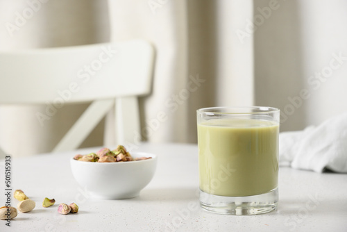 Wallpaper Mural Pistachio milk in glass and pistachios in glass jar on white kitchen background. Lactose free. Vegan nutty plant based milk. Vertical. Torontodigital.ca