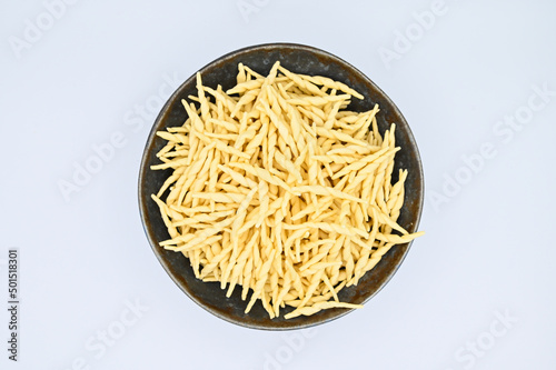 Top view of raw trofie pasta on a white background
