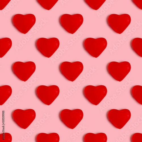 Seamless pattern with jelly candy in the form of heart on pink background.