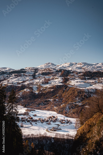 Vertical view of Tersnaus in snow, a village in Val Lumnezia, Switzerland photo