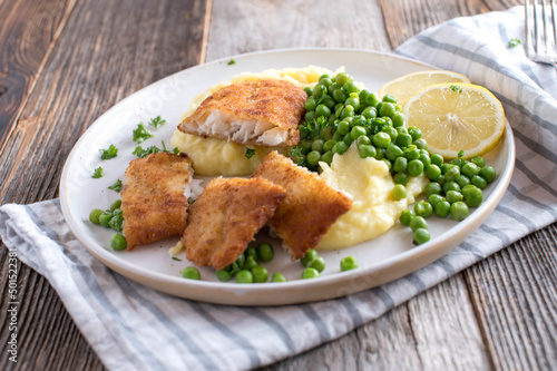 Breaded redfish with mashed potatoes and green peas