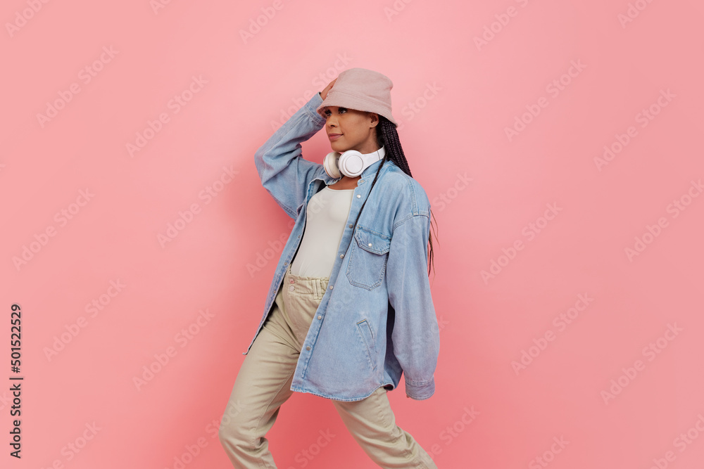 Portrait of female fashion model in casual style outfit isolated on pink background. Concept of beauty, art, fashion, youth Portrait of female fashion model in casual style outfit isolated on pink background. Concept of beauty, art, fashion, youth