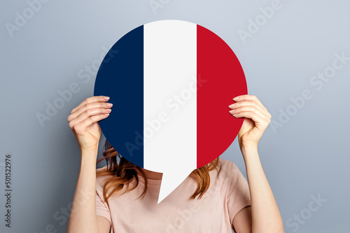 France elections vote concept. Student girl holds poster with france flag isolated over grey studio background photo