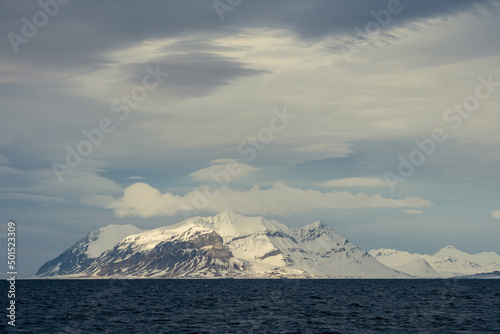 Panoramic view of Blue hour of the mountains, snow and Sea in Svalbard, Norway.