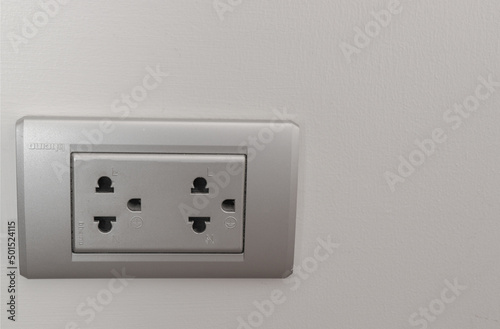 Electrical switch and plug on wall white