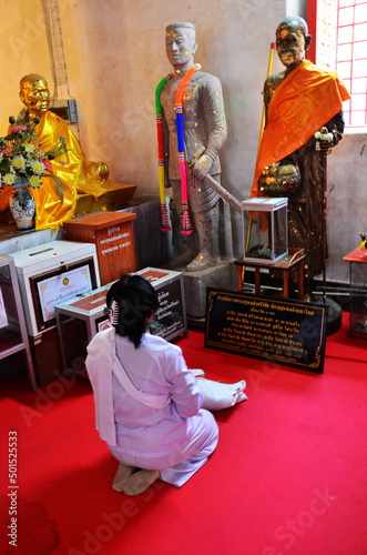 Thai nun women people travel visit and respect praying blessing holy worship with Kruba Sriwichai or Khruba Siwichai statue and deity at Wat Si Khom Kham temple on March 15, 2022 in Phayao, Thailand photo