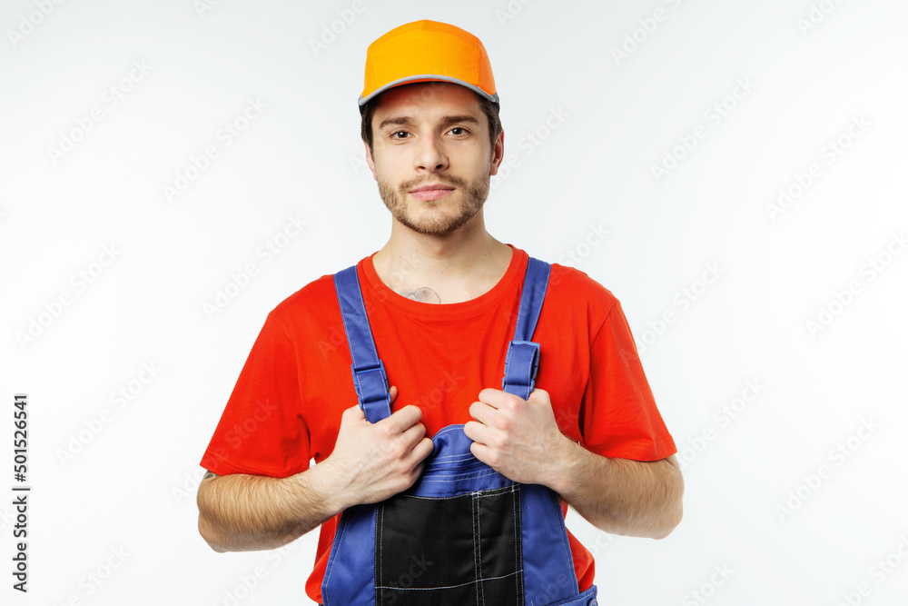 Attractive man in an engineer's work uniform, worker on white background