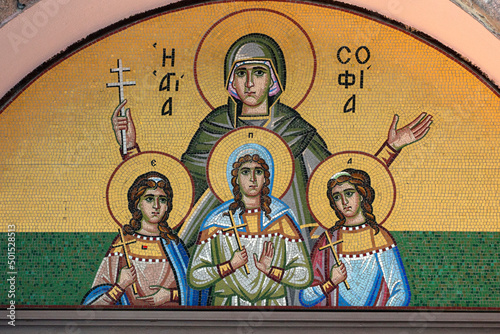 mosaic hagiography of Agia Sophia and her daughters Faith, Hope, Love ,on the facade above the entrance of a greek church