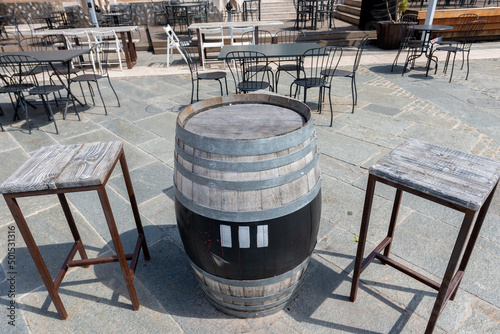 dehor with chairs, tables and barrel photo