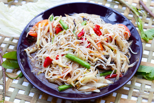 Spicy green papaya salad with vermicelli on white