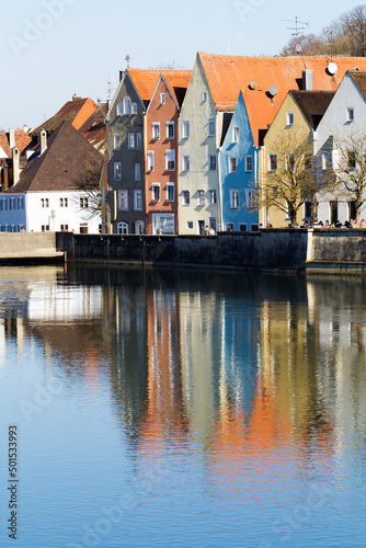 Colorful beautiful city houses on the coast illuminated by the sun. Cityscape Landsberg Am Lech reflected in the river. River Lech, Romantic Road Bavaria Germany