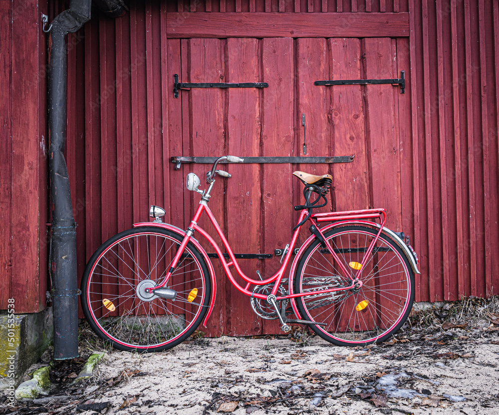 red bicycle in front of a wall