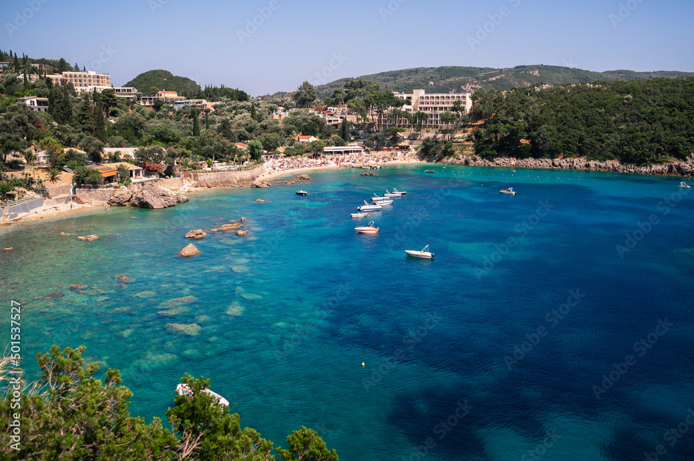 Paleokastritsa bay on sunny day. Bay with beautiful turquoise water and boats.
